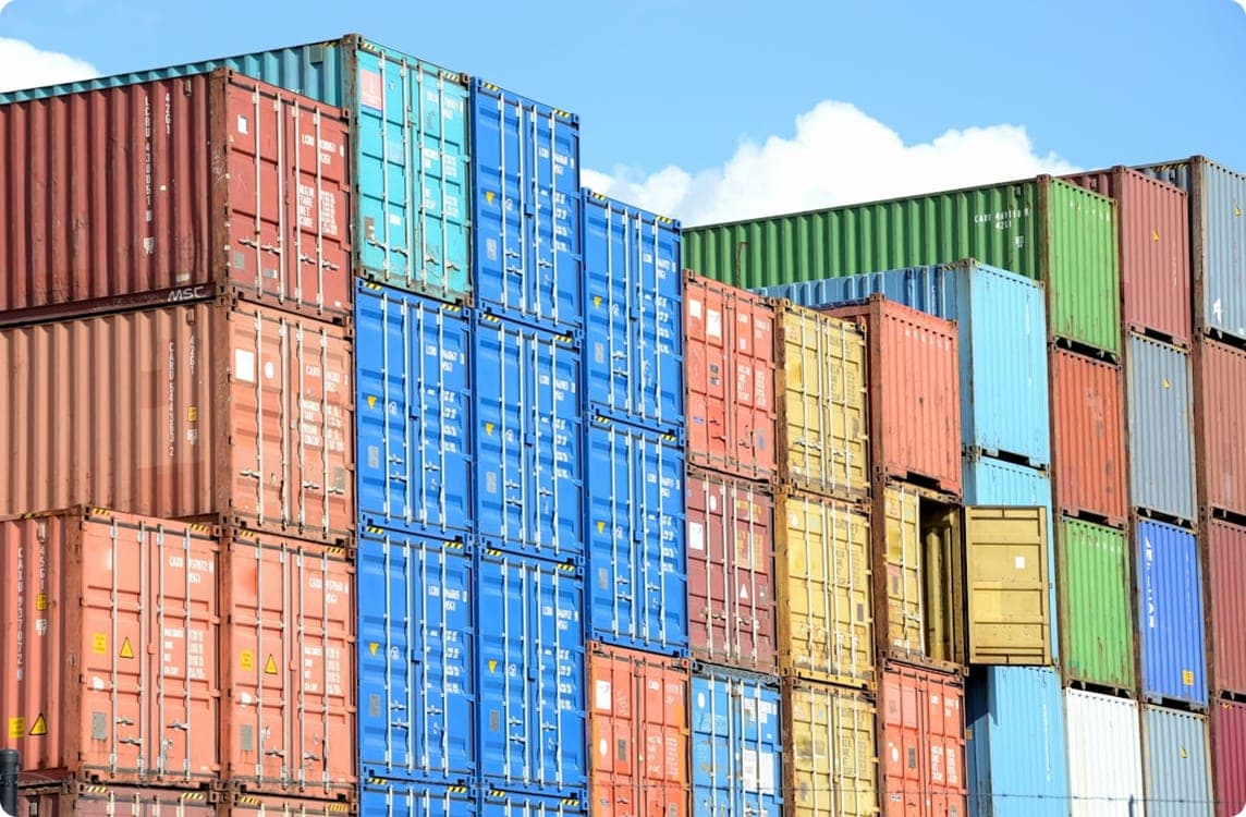 Stacked shipping containers in a port yard