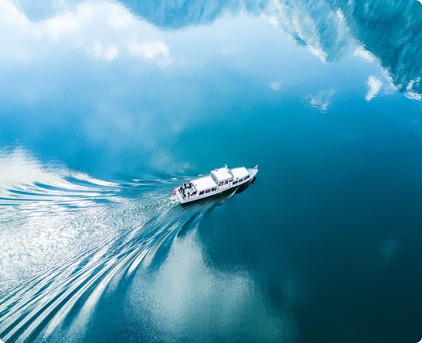 Launch boat crossing open water toward the anchorage